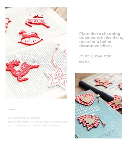 Detail of wooden Christmas ornaments with red elk and star shapes on vintage books