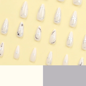 Elegant cream white press-on nails with silver abstract lines and star nail art ornaments