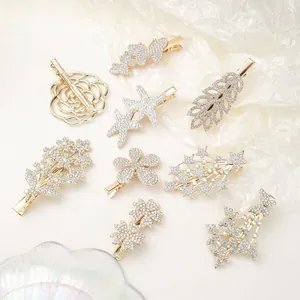 Macro shot of assorted gold rhinestone hair clips in floral and butterfly designs