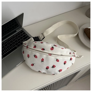 Detail of white corduroy waist bag with strawberry prints and adjustable strap buckle
