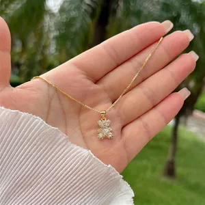 Detailed view of an 18K gold plated bear pendant necklace with sparkling white zircons