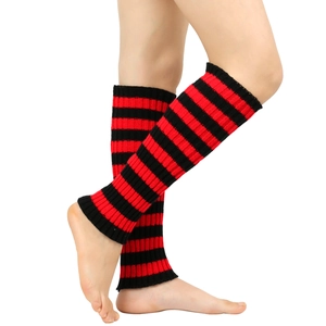 Detail of red and black striped knitted leg warmers showing soft ribbed texture and pattern