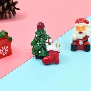 Miniature resin Christmas decorations featuring Santa, tree, socks and gift box