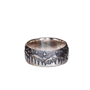 Vintage silver couple ring with mountain and starry sky relief on white background