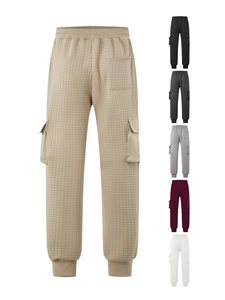 Detail of khaki men's quilted cargo joggers showing fabric texture and side flap pockets