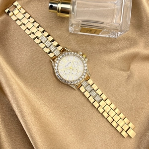 Luxurious gold zircon watch with rhinestone bezel and three-subdial display on silk fabric