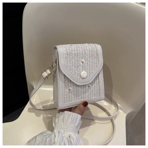 White woven shoulder bag with daisy embroidery detail and adjustable strap