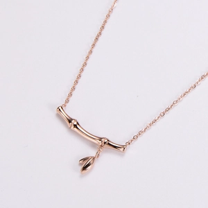 Bamboo-style rose gold necklace with leaf charms on a clean white background