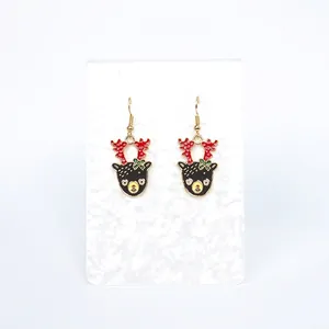 Christmas reindeer drop earrings with red antlers and green bowknot on white card