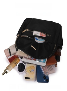 Large capacity black nylon backpack showing main compartment storage with everyday essentials
