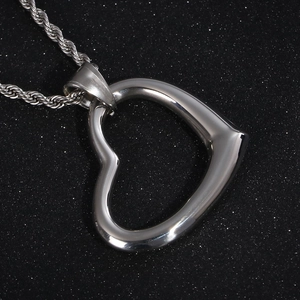 Detailed macro view of a silver stainless steel hollow heart pendant on a twist chain