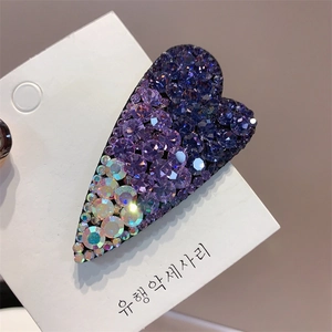Macro close-up of sparkling purple rhinestones on a heart-shaped luxury hair clip