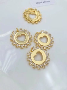 Detailed view of heart shaped gold pendant with cubic zirconia inlay for jewelry making