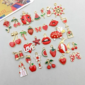 Assorted red enamel alloy charms featuring cherry, strawberry, and heart shapes for DIY jewelry