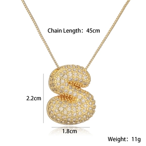 Detail shot of gold S letter pendant with clear stones and size dimensions text