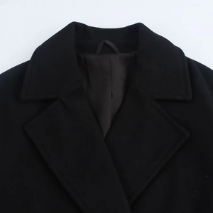Close-up of elegant black wool coat lapel with soft texture and refined stitching detail