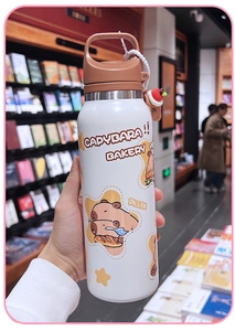Close-up of white stainless steel water bottle with cute Capybara cartoon and carry handle
