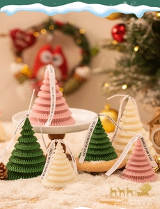 Detailed view of tree-shaped scented candles with ribbon and elegant layered textures