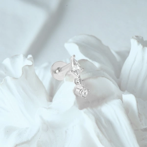 Macro detail of s925 silver moon stud earring with rhombus and round clear gemstones