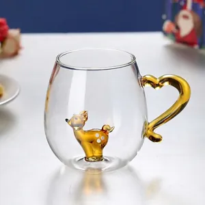 Detail of amber glass reindeer sculpture and heart handle inside a clear mug