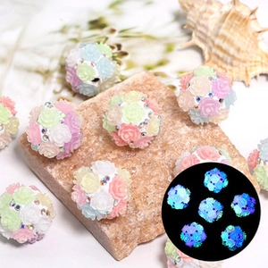 Luminous floral resin beads with rhinestones and glowing effect shown in detail