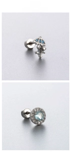 Detailed macro view of titanium steel helix earrings with blue zircon umbrella and halo studs