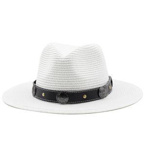 Detail of white straw Panama hat featuring black band with vintage metal studs and buckle