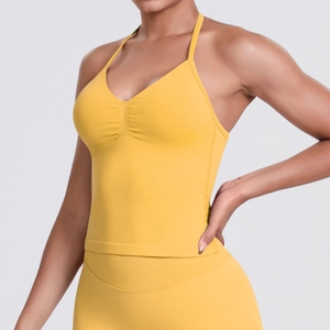 Detail view of bright yellow seamless sports set with V-neck top and high waist leggings
