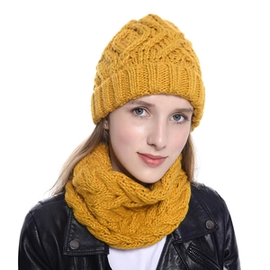 Women's yellow knitted beanie and scarf set featuring thick warm yarn for winter