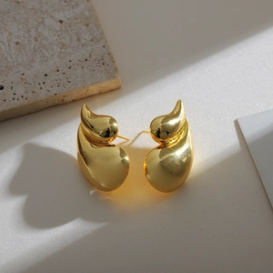 Minimalist 18K gold double waterdrop brass earrings for women on a stone base