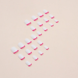 Short oval French press-on nails with white base and magenta tips in 24-piece set