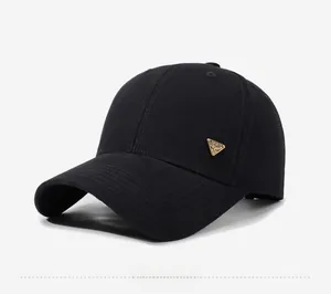 Close-up of a black baseball cap featuring a distinctive golden triangle Spirit badge