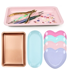 Collection of rectangular, oval, and heart-shaped metal storage trays in pastel colors