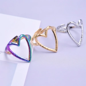 Three open heart rings in gold, silver, and rainbow colors with hammer textured finish