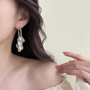 Elegant silver tassel petal earrings with geometric leaf fringe on female model