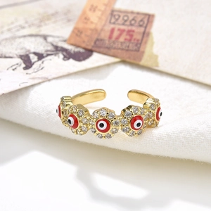 Detailed view of an 18K gold plated evil eye ring with red enamel and clear zircon inlay