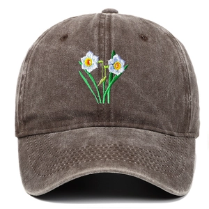 Close-up of vintage washed cotton baseball cap with white flower embroidery details