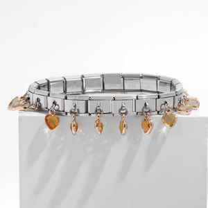 Detail of stainless steel link bracelet with amber heart charms on white display