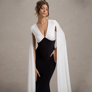 Elegant sleeveless V-neck long dress in black and white contrast with flowing sleeves