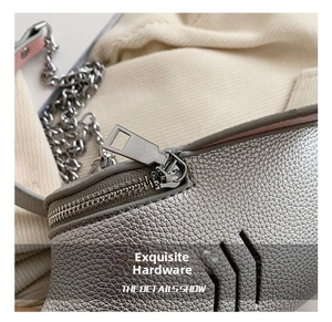 Detailed macro view of silver lychee grain leather texture and premium metal zipper