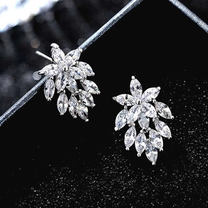 Close-up of silver stud earrings with marquise-cut zircon in a floral leaf design