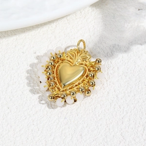 Luxurious gold woven heart pendant with white bead trim and small golden beads detail