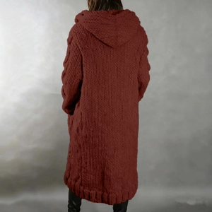 Macro detail of the chunky cable knit texture and hood on this rust red long cardigan