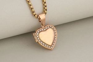 Macro view of rose gold heart locket pendant with side hinge and crystal border