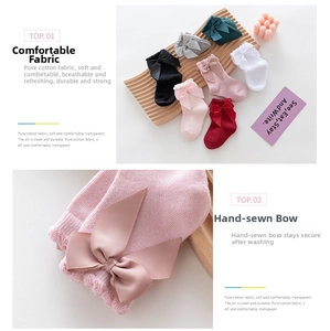Detail of hand-sewn oversized ribbon bow and delicate lace trim on pink cotton baby socks