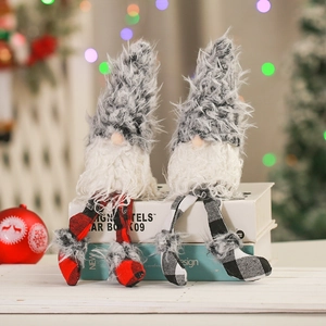 Christmas gnome plush dolls with long legs in plaid hats sitting on books for festive decor