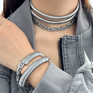 Silver layered snake chain and H-link necklace with matching bracelet set on model