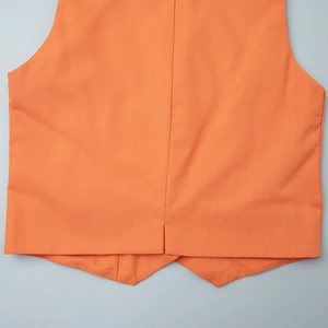 Detail view of the orange linen vest featuring a back split seam and clean stitching