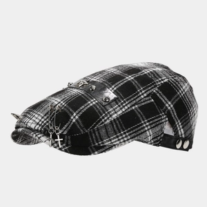 Detail of checkered beret with leather strap, metal star badge and punk rivets