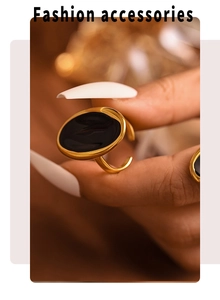 Detail of a French oval gold ring with black enamel inlay on a model's hand